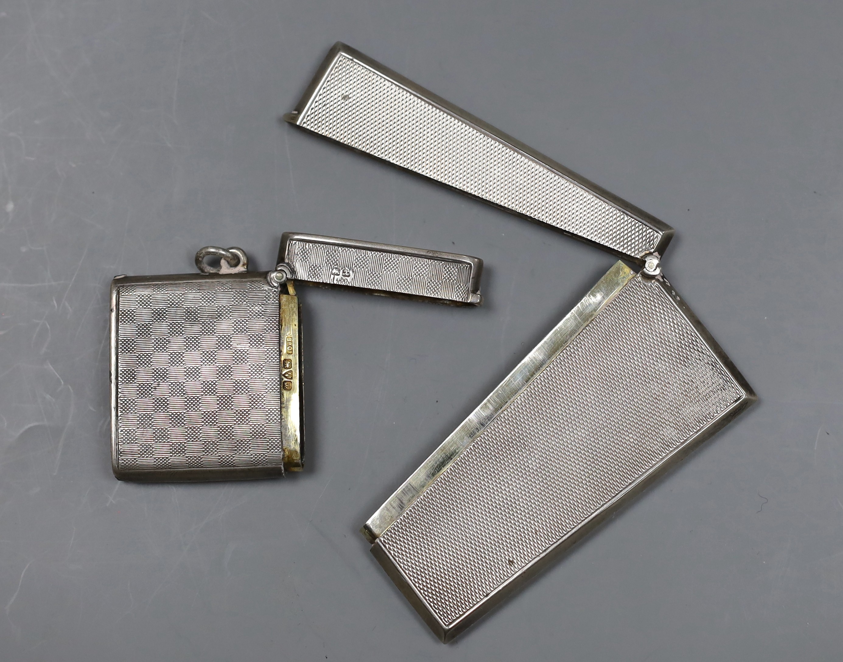 A German 800 standard white metal mounted glass hip flask, 14cm, a George V silver vesta case and a 1920's engine turned silver card case.
